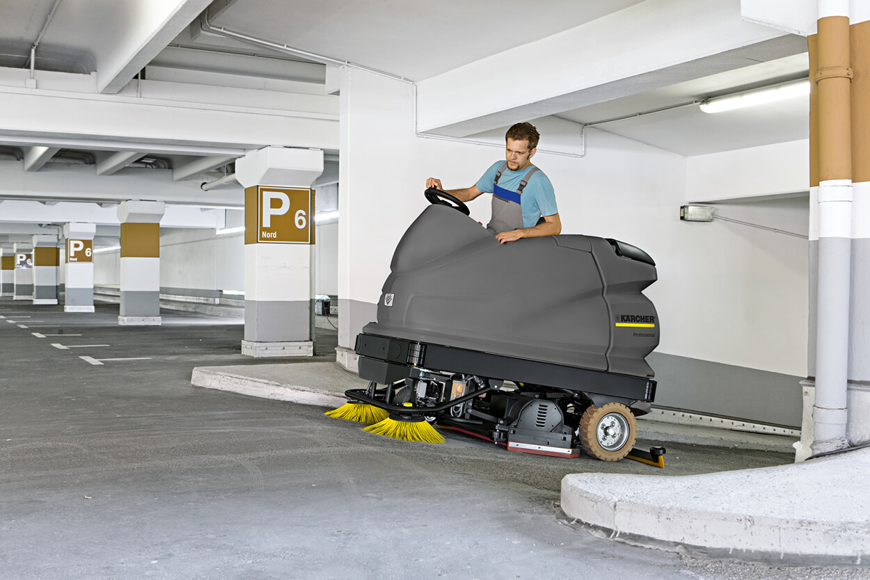 Man operating B 250 R Scrubber cleaning machine in empty car park