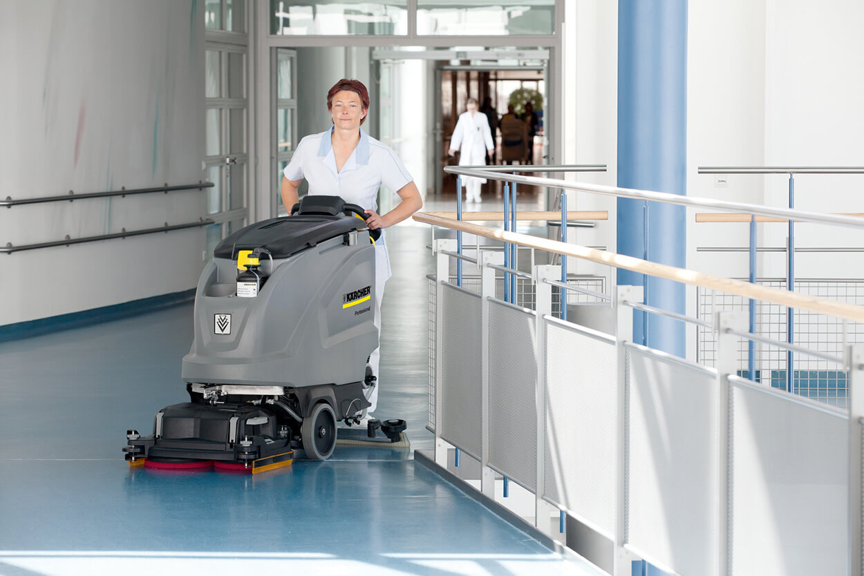 Women operating B 60 W Scrubber Dryer cleaning machine at hospital