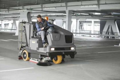 Combination sweeper scrubber cleaning a car park