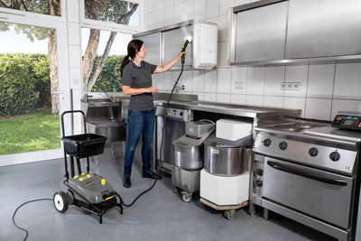 Steam cleaner cleaning a kitchen