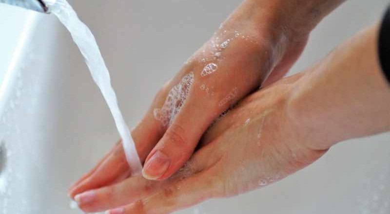 Person washing their hands under running water