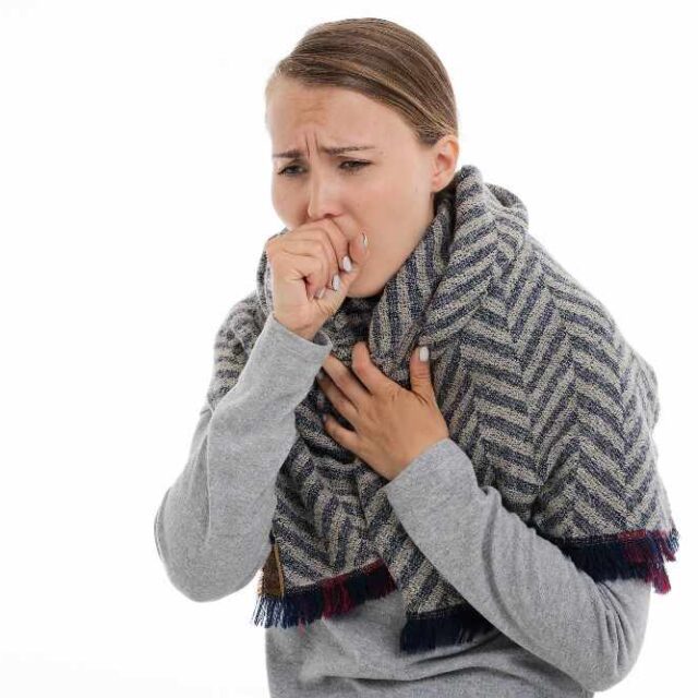woman coughing due to infection in the workplace